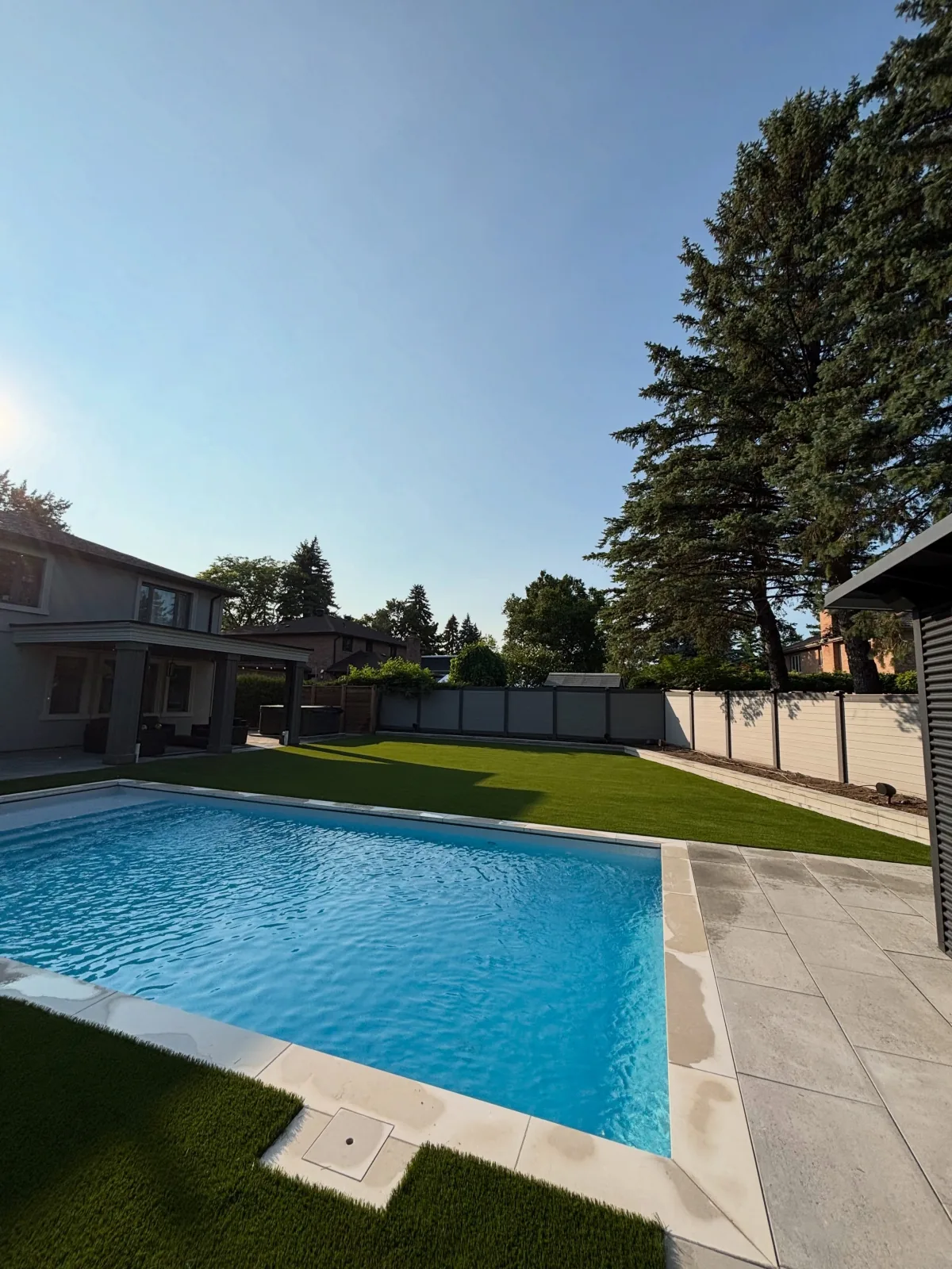 Artificial grass installed around a backyard pool in Markham